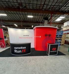 RENTAL: Modified RE-2042 Inline Design with Gravitee One-Step Panel System Backwall with Curved Panels, Storage Closet with Locking Door, White Laminated Soffit, RE-1205 Large Curved Reception Counter with Black Laminated Top, RE-1228 Small Curved Counter